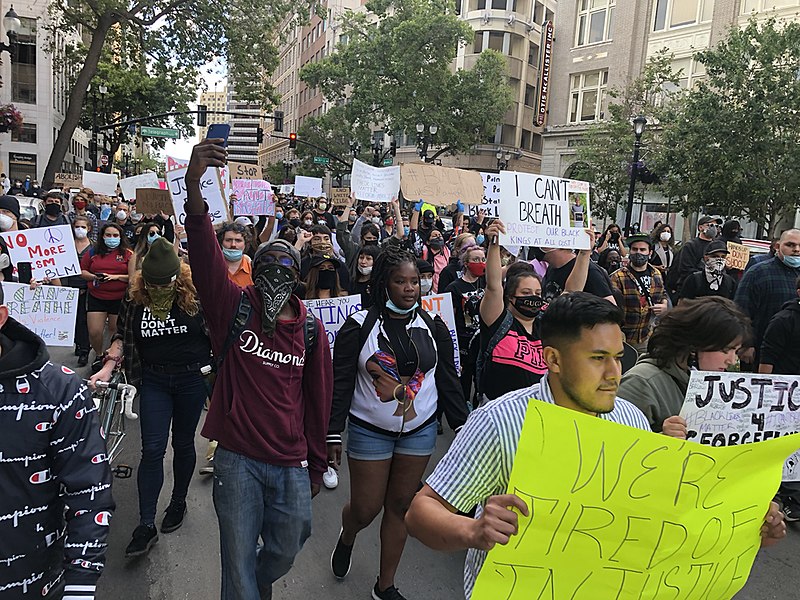 Black Lives Matters protesters march in the streets with signs in Oakland, California in May of 2020.