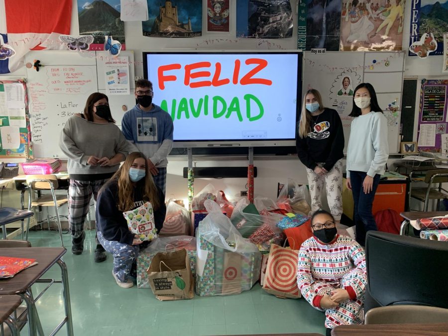 Spanish Club members pose with the bags of wrapped gifts that were purchased.