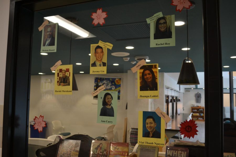 The FM High School library displays a AAPI sign with colorful flowers and pictures of prominent authors.
