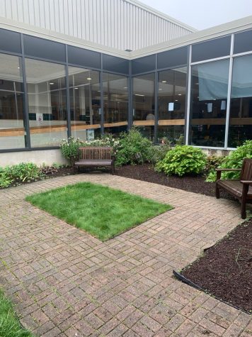 The Shakespeare Garden features a center grass area surrounded by a brick walking path.