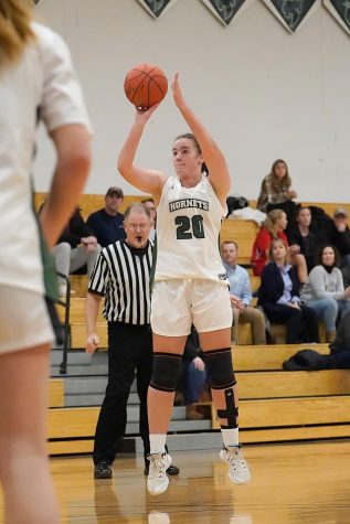 Ashley Schneider shoots a three point shot from the wing.