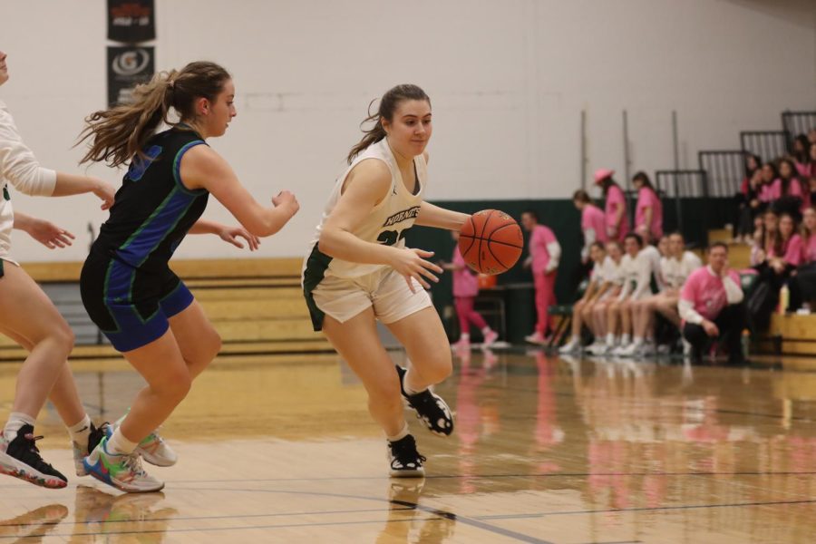 Evie Kawa drives to the basket with a defender looking to cut her off.