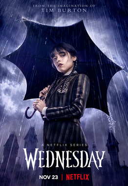 The Wednesday Netflix promotional poster shows the main character standing in the rain with a black umbrella in front of the creepy family mansion.