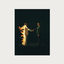 The album cover for Heroes and Villains by the artist Metro Boomin shows a man on fire shaking hands with a second man.