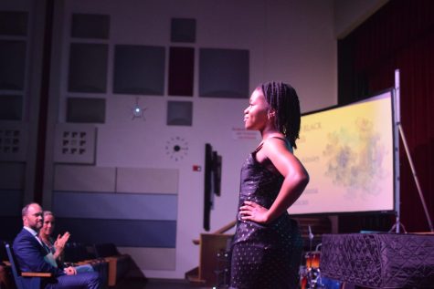 A student models her outfit--a black print dress.