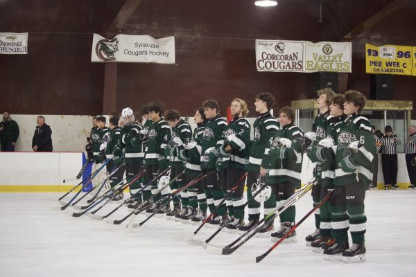 FMs hockey team listens to the National Anthem.