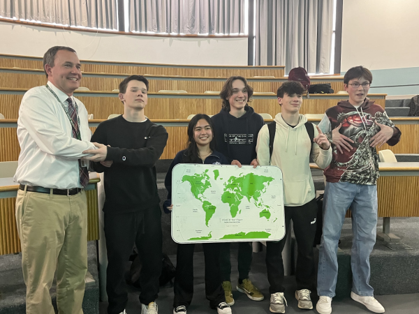 The newly elected leadership poses with Mr. DeLans with a fisheries world map in front of them.