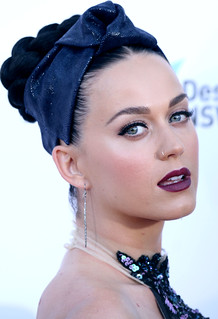 Katy Perrys headshot where she wears a deep blue headband.