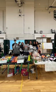 Club members pose in front of their concession stand at the handball tournament.