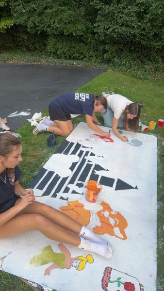 Students painting a display.