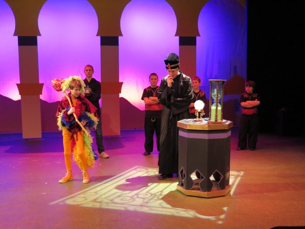 Performers act out a scene from the musical.