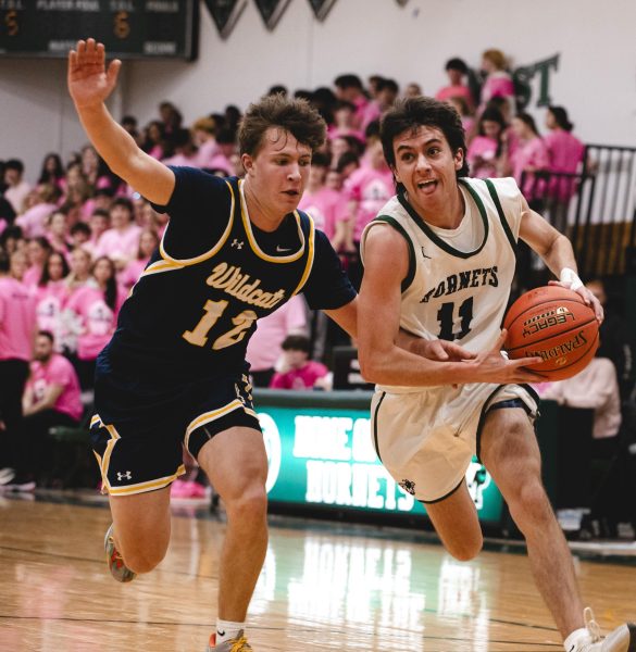 An FM boys' team player drives on his opponent.