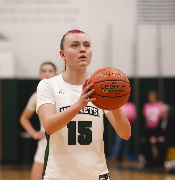 An FM player on the girls' team lines up to take a free throw shot.