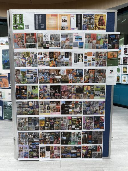A large stand up board displays artwork from various students this school year.