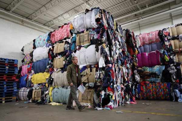 Bolts of cloth are stacked up to the ceiling during a Goodwill warehouse tour.