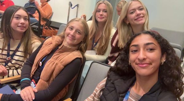 5 students are sitting in the Newhouse lecture hall.