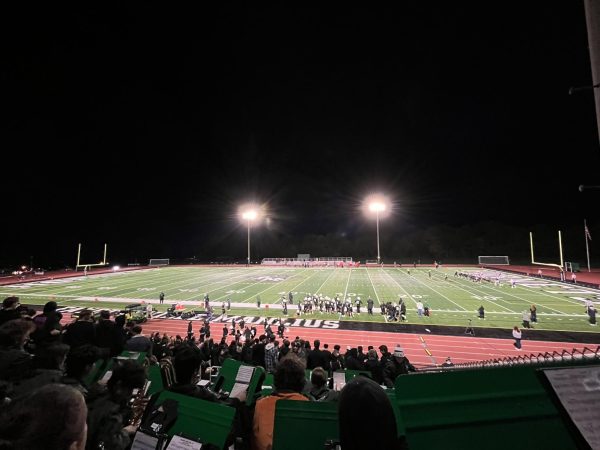 Students are looking out at the field as the team kicks an extra point.