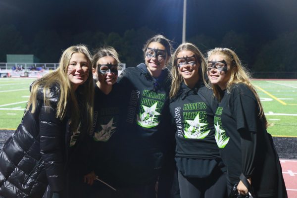 Five girls pose with Batman face paint.