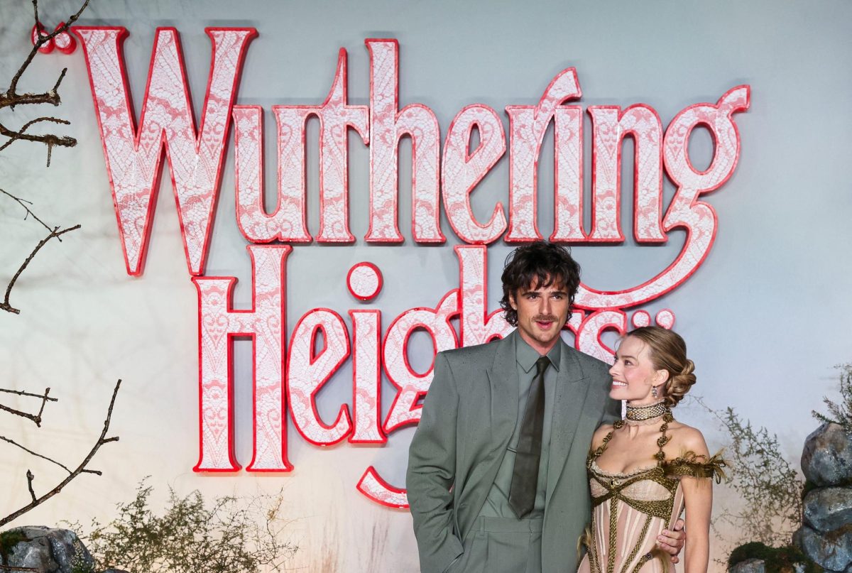 The promotional image shows the two primary actors dressed formally to attend the film premiere. The film title is in the backdrop in a hearts wallpaper styled lettering highlighted in a pinkish red outline.