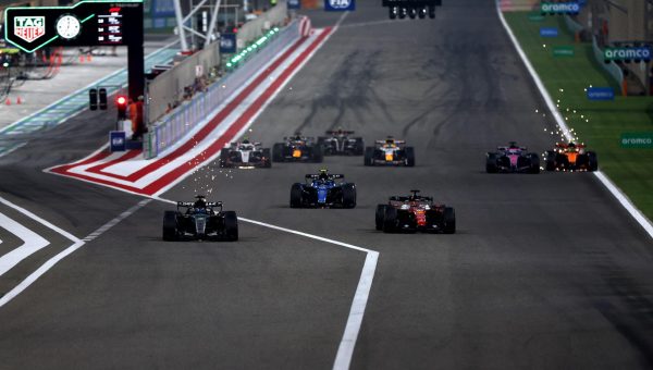 F1 cars are aligned across the track.