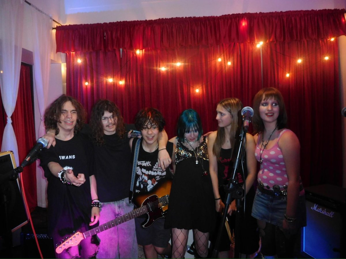 Members of the band pose at a show.
